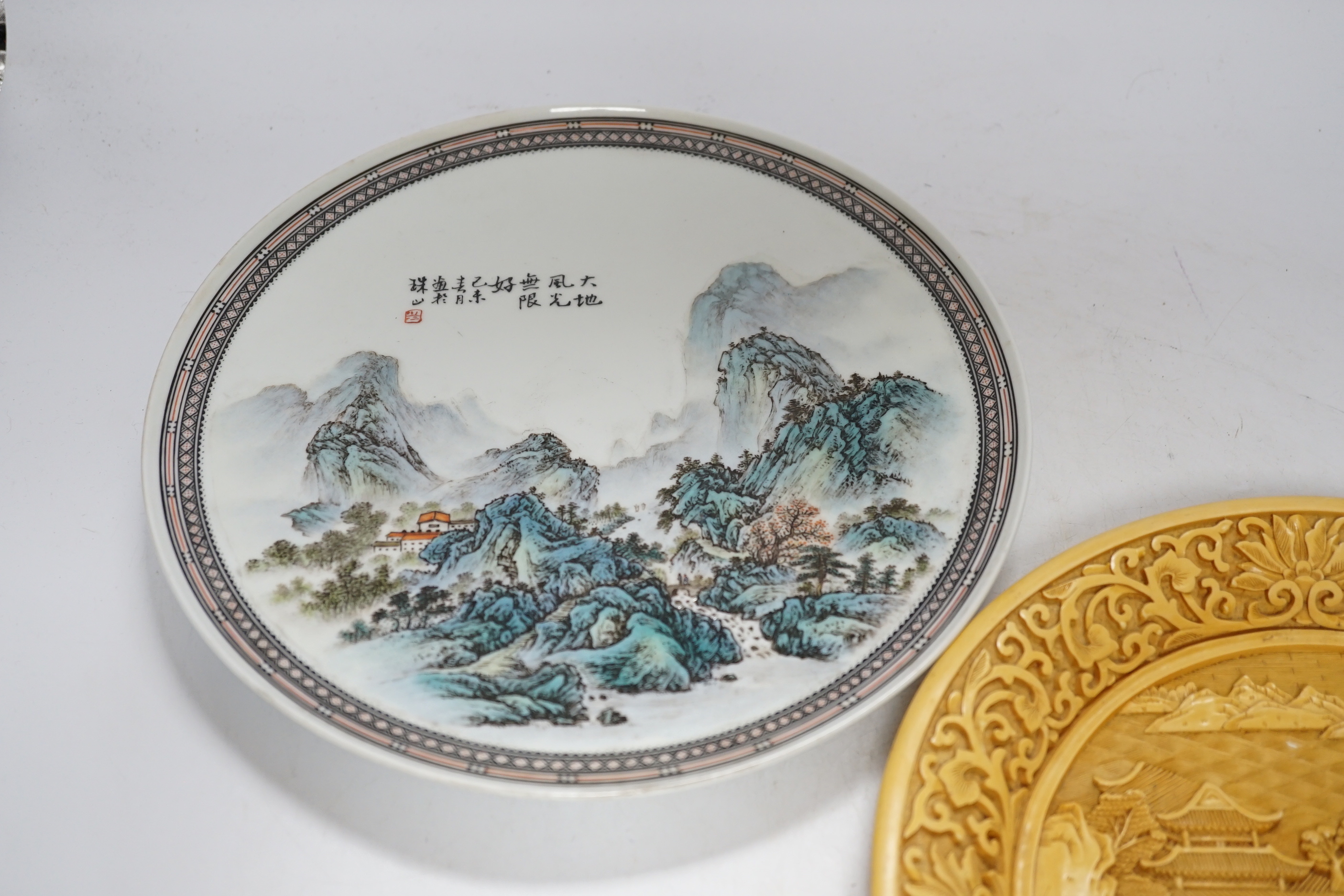 Two Chinese plates, resin and porcelain, largest 26cm diameter